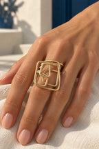 LOCO CUBE SPIRAL RING by Monica Krexa, gold ring worn on a hand, cream editorial hero